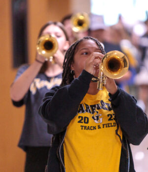 Freshman trumpeter Sunny Oliver performs with the Marching Pride as they parade through the hallways of GHS ahead of a homecoming Pep Rally. Photo: Benjamin Coll/JAG Schools