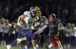 Huskies football shut out by Hornets in regular season finale Kirtland #18 Will Beers gets pursued by Cardinal #1 Aiden Gallagher.