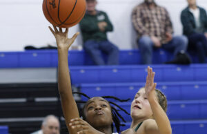 Raven girls basketball hits offensive lull in loss against Colts Ravenna #0 Miriyha Sandifer attempts lay up over Cloverleaf defender/Photo by Anton Albert