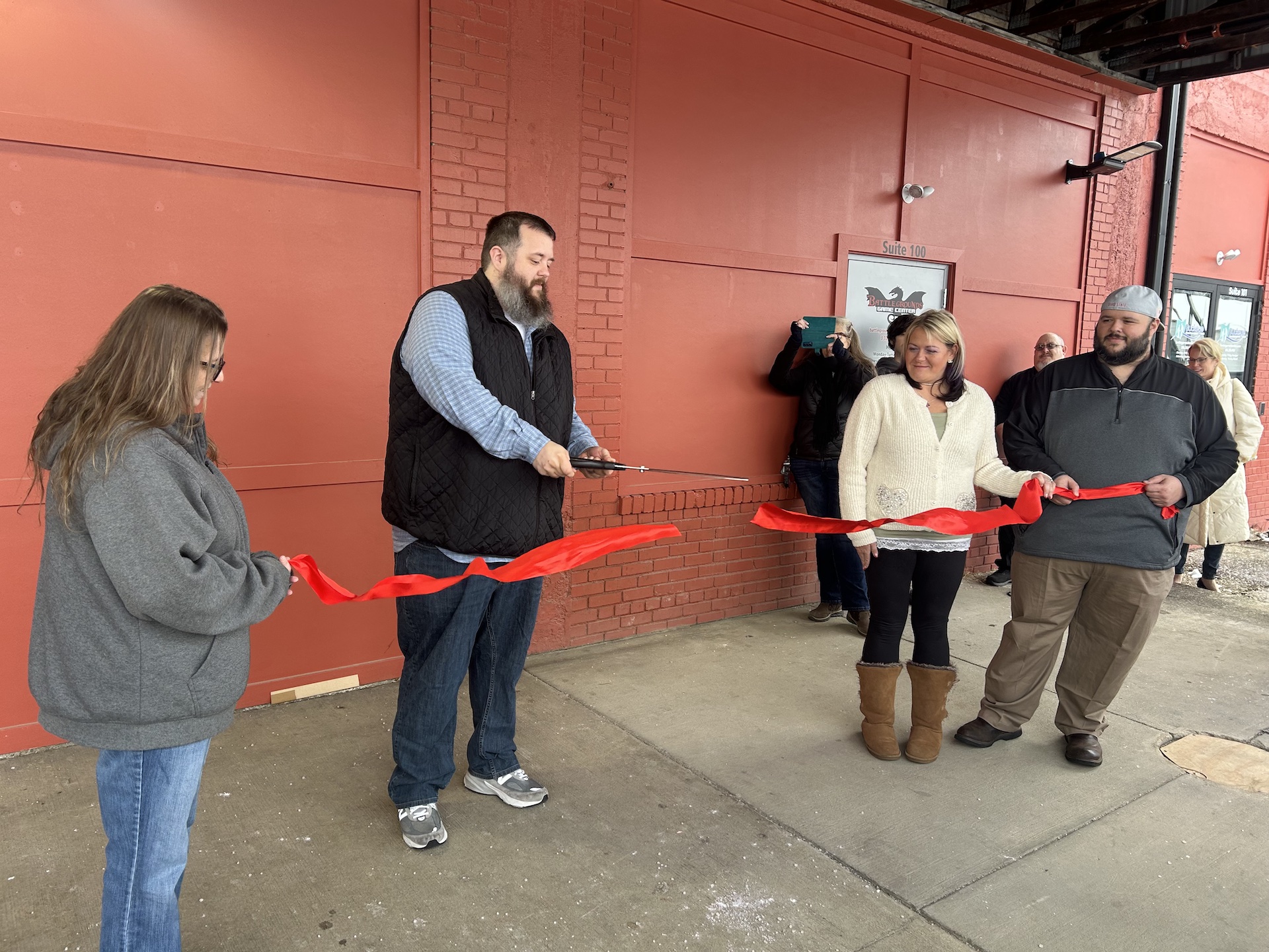 The co-owners of Buckeye Residential Solutions and Battlegrounds Gaming Center proudly cut the ribbon/Photo by Daniel Sherriff