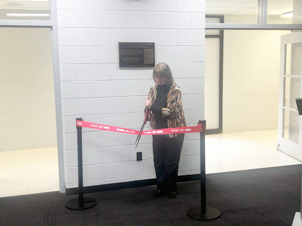Diane Paulenich cuts the ribbon to officially commemorate the Fred F. Paulenich Learning Commons Area at Crestwood High School last Saturday in Mantua/Photo by Daniel Sherriff