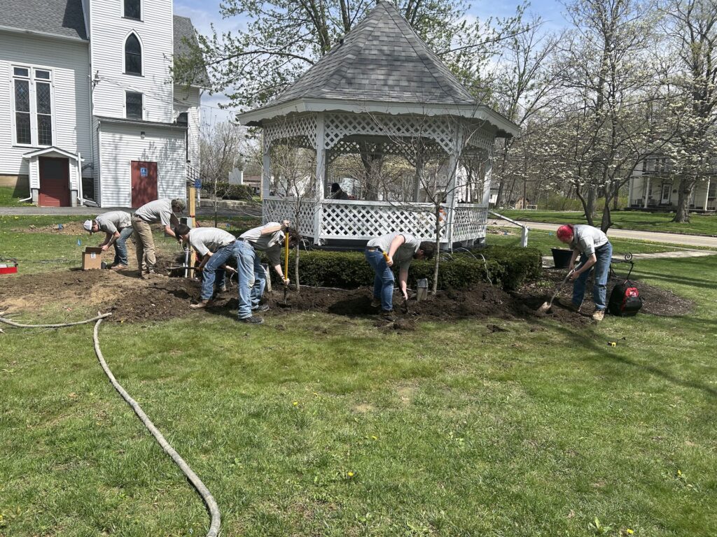 Maplewood Career Center students work to lay the power lines for Windham Township's street clock and gazebo/Photo by Daniel Sherriff