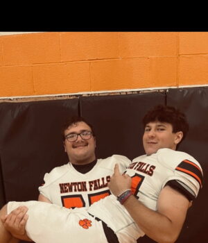 Teammate Landon Bryant holding Spencer Sabo