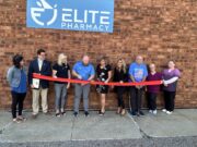 Elite Pharmacy welcomed to Ravenna with Grand Reopening ceremony Elite Pharmacy Co-Owner Jake Sweet cuts the ribbon to commemorate the official grand re-opening on Monday in Ravenna - Photo by Daniel Sherriff