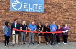 Elite Pharmacy welcomed to Ravenna with Grand Reopening ceremony Elite Pharmacy Co-Owner Jake Sweet cuts the ribbon to commemorate the official grand re-opening on Monday in Ravenna - Photo by Daniel Sherriff