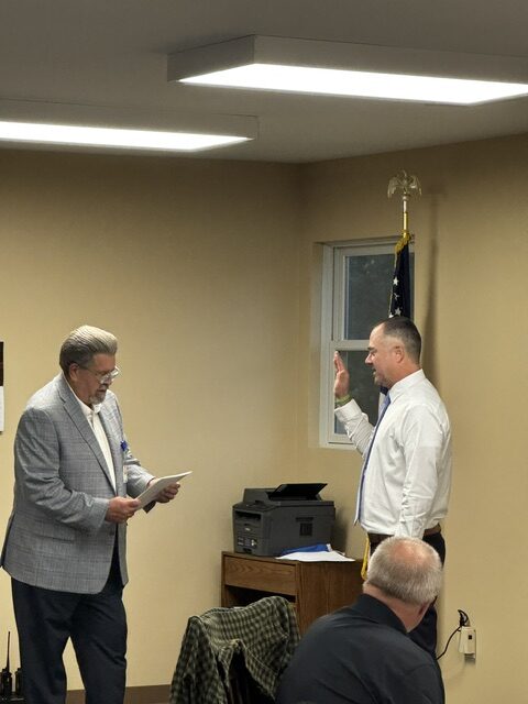 Commissioner Mike Tinlin swearing in Assistant Chief Jason Groselle - Photo by Stacy Turner