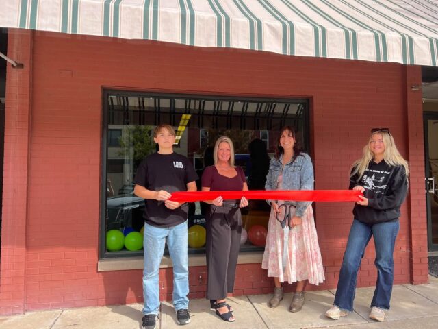Ruoff Mortgage Senior Loan Officer Tara Jenior (second from right) proudly cuts the ribbon to commemorate the grand opening of Ruoff Mortagage's Ravenna Branch alongside her children Kolten (far left), Koralee (far right) and Ravenna Mayoral Candidate Cherly Wood (second from left) - Photo courtesy of Tara Jenior Ruoff Mortgage Senior Loan Officer Tara Jenior (second from right) proudly cuts the ribbon to commemorate the grand opening of Ruoff Mortagage's Ravenna Branch alongside her children Kolten (far left), Koralee (far right) and Ravenna Mayoral Candidate Cherly Wood (second from left) - Photo courtesy of Tara Jenior