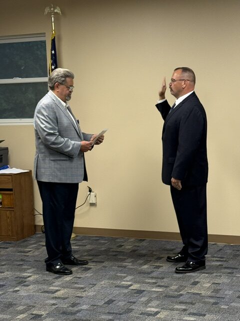 Commissioner Mike Tinlin swearing in Captain Chris Sanchez - Photo by Stacy Turner